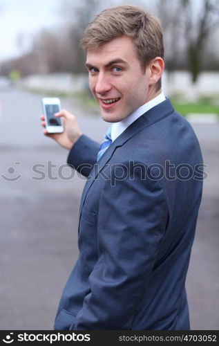 Portrait of young attractive man calling by phone