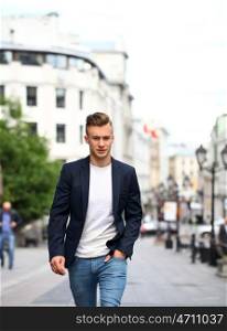 Portrait of young attractive man on the street