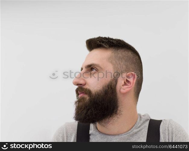 portrait of young bearded hipster handyman isolated on white background
