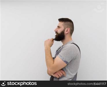 portrait of young bearded hipster handyman isolated on white background