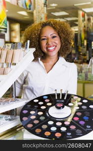 Portrait of young beautician at cosmetic counter