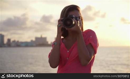 Portrait of young beautiful blond girl in la habana, cuba, taking pictures and photos