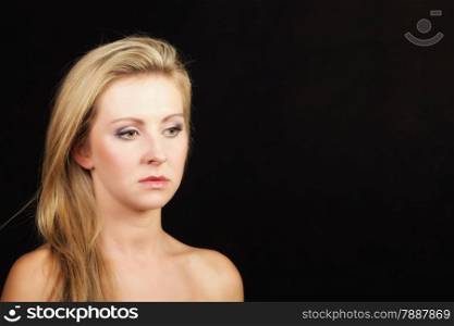 Portrait of young beautiful blonde girl with make up black background