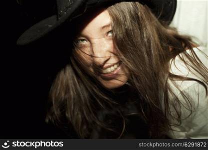 Portrait of young beautiful brunette woman wearing cowboy hat closeup