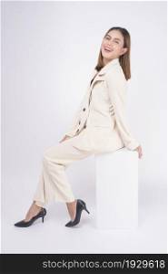 Portrait of young beautiful businesswoman wearing suit in white background studio.
