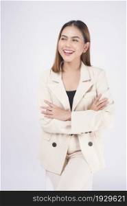 Portrait of young beautiful businesswoman wearing suit in white background studio.