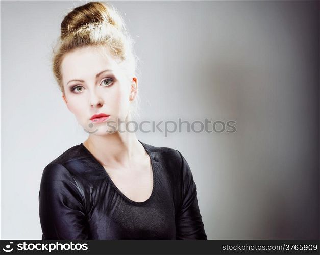 Portrait of young beautiful girl blonde make up and hair bun