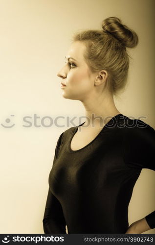 Portrait of young beautiful girl face profile blonde woman makeup and hair bun vintage aged tone