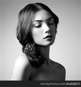 Portrait of young beautiful girl. Fashion photo. Girl with a vintage brooch in her hair