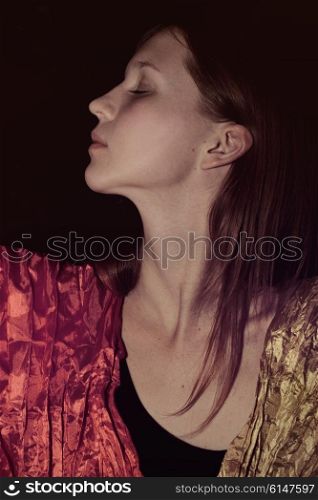 Portrait of young beautiful girl on black background