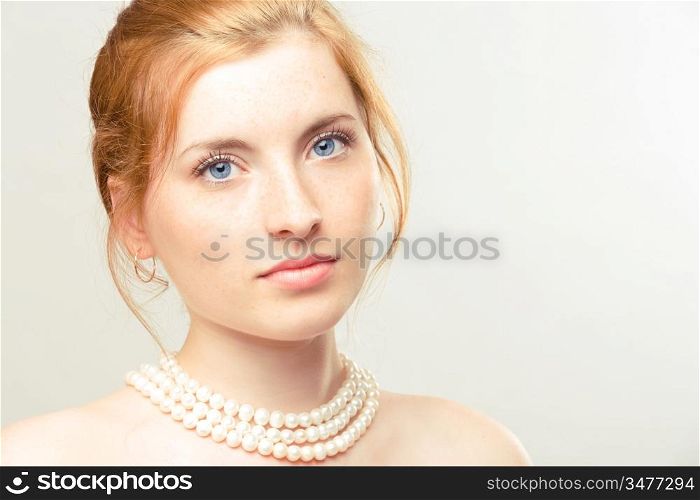 portrait of young beautiful girl with pearl necklace