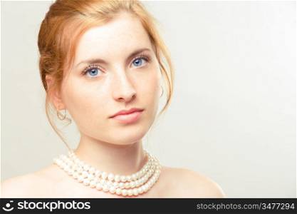portrait of young beautiful girl with pearl necklace