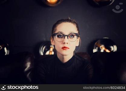 Portrait of young beautiful sad woman dressed in eyeglasses