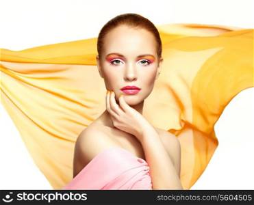 Portrait of young beautiful woman against flying fabric. Beauty woman face closeup. Professional makeup
