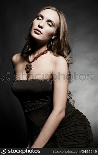 Portrait of young beautiful woman in an elegant evening dress