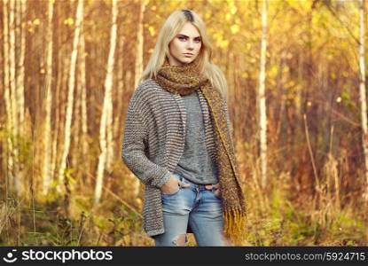 Portrait of young beautiful woman in autumn pullover. Fashion photo. Blonde girl. Perfect make-up