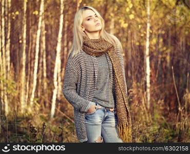 Portrait of Young beautiful woman in autumn pullover. Fashion photo. Blonde girl. Perfect make-up