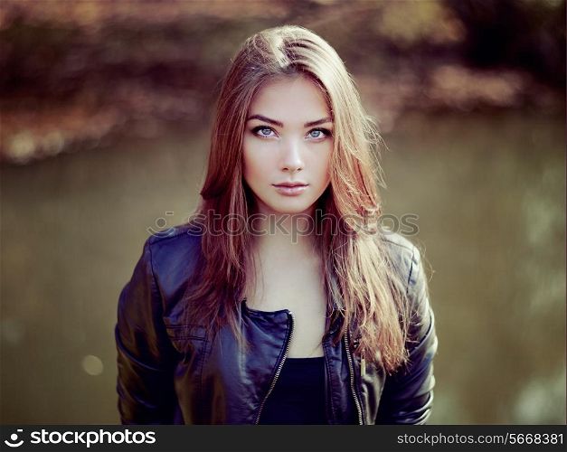 Portrait of young beautiful woman in leather jacket. Fashion photo