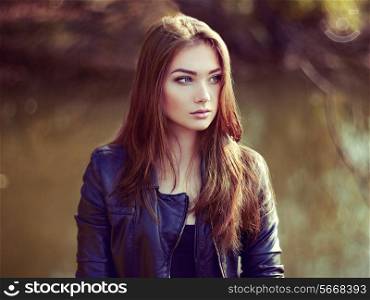 Portrait of young beautiful woman in leather jacket. Fashion photo