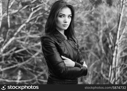 Portrait of young beautiful woman in leather jacket. Fashion photo. Black and white