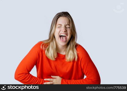 Portrait of young beautiful woman laughing on studio.