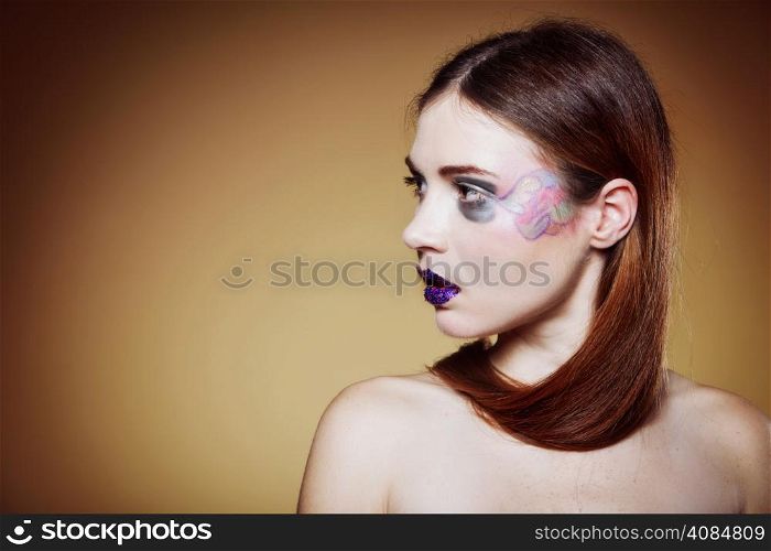 portrait of young beautiful woman long hair colorful make up brown background