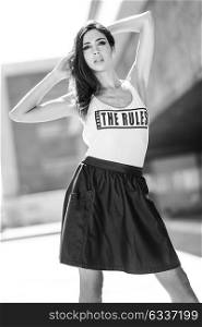Portrait of young beautiful woman, model of fashion, wearing t-shirt and skirt