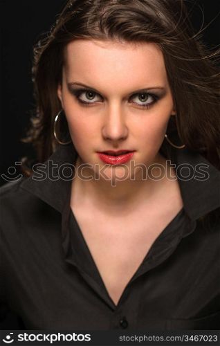 Portrait of young beautiful woman on dark background