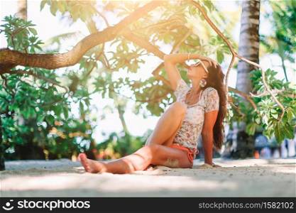 Portrait of young beautiful woman on the beach. Woman on the beach enjoying summer holidays