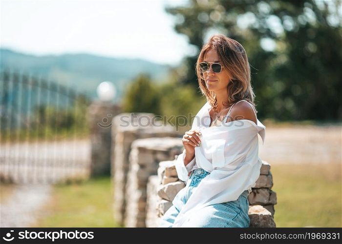 Portrait of young beautiful woman outdoors. Portrait of young attractive tourist woman outdoors