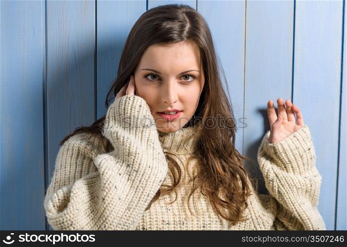 Portrait of young beautiful woman wearing winter beige sweater