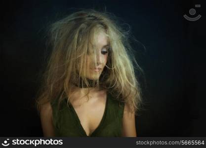 Portrait of young beautiful woman with disheveled curly hair