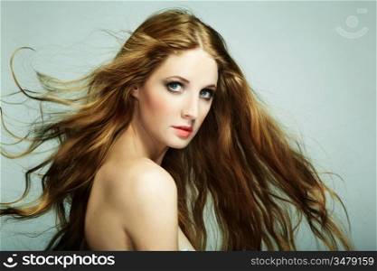 Portrait of young beautiful woman with long flowing hair