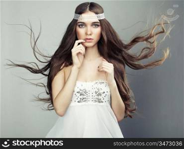 Portrait of young beautiful woman with long flowing hair. Fashion photo