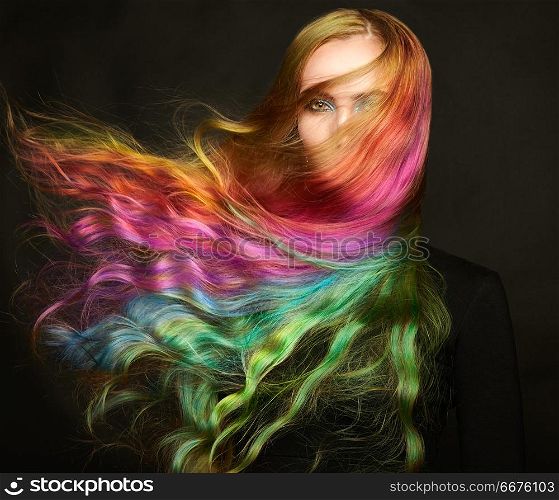 Portrait of young beautiful woman with long flying hair. Portrait of young beautiful woman with long flowing hair. Model with perfect Healthy Dyed Hair. Rainbow Hairstyles