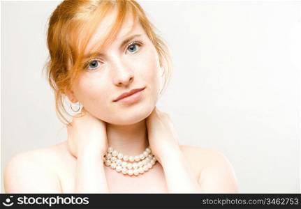 portrait of young beautiful woman with pearl necklace