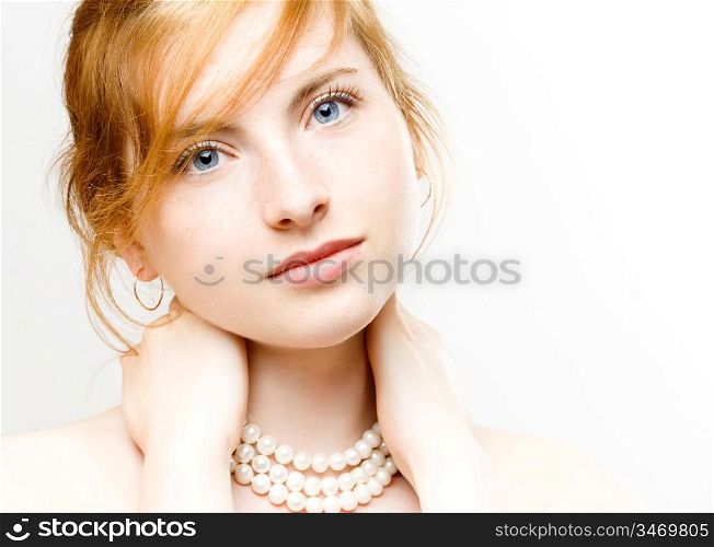 portrait of young beautiful woman with pearl necklace