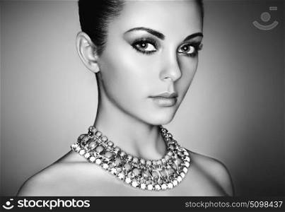 Portrait of young beautiful woman with perfect makeup. Face Girl with necklace close up. Fashion jewelry. Black and White photo