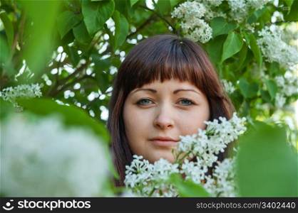 Portrait of young beautiful woman with pipe-tree.