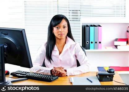 Portrait of young black business woman at desk in office