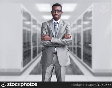 Portrait of young black man in rack server room. computer network server room 3d render representing internet and hosting company and data center concept