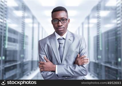 Portrait of young black man in rack server room