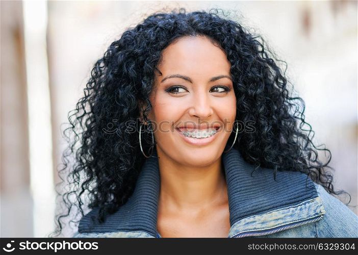 Portrait of young black woman smiling with braces