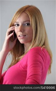 Portrait of young blond woman with mobile phone