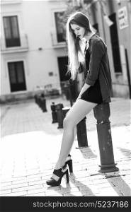 Portrait of young blonde girl wearing casual clothes in urban background