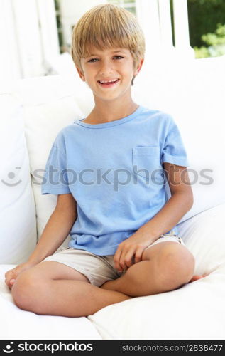 Portrait Of Young Boy Relaxing On Sofa