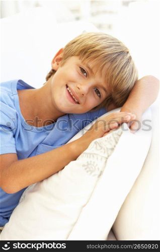 Portrait Of Young Boy Relaxing On Sofa