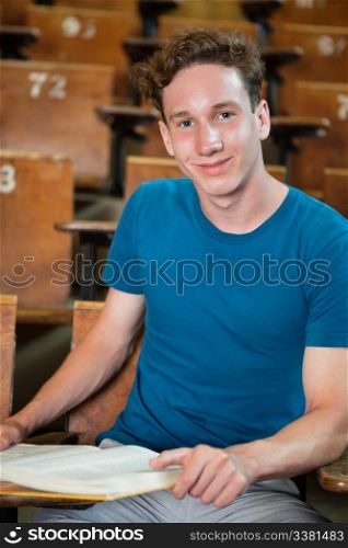 Portrait of young boy sitting in lecture hall