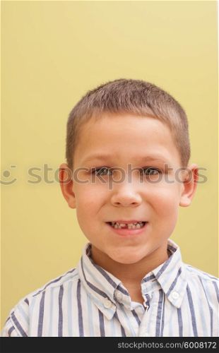 Portrait of young boy who lost his milk teeth. First lost tooth