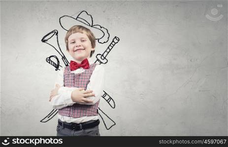 Portrait of young boy with drawn hat and guns behind his back